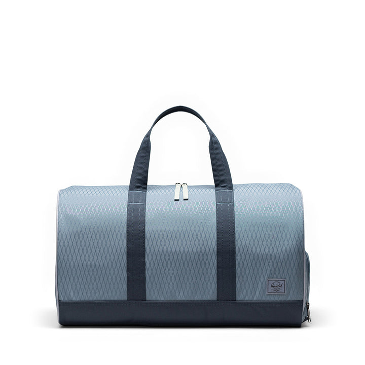 Blue duffel bag with black straps on a white background